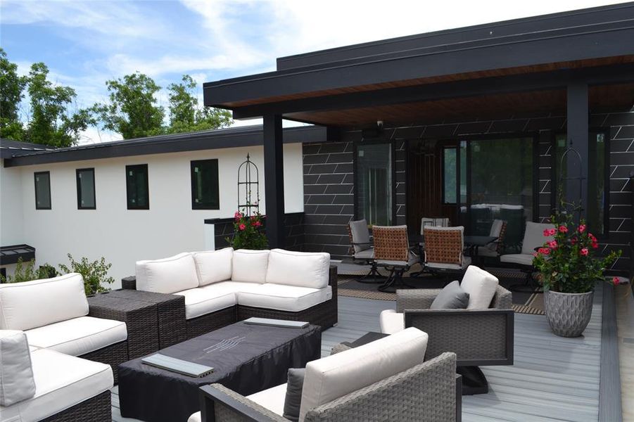 Wooden deck featuring outdoor lounge area and outdoor dining space Wooden deck featuring outdoor lounge area and outdoor dining space