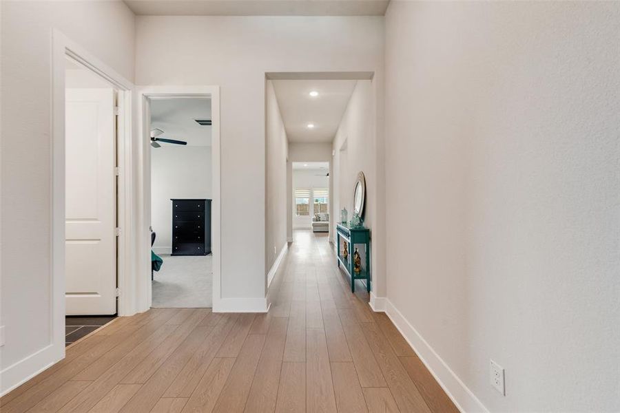 Hallway featuring light wood-style flooring and recessed lighting