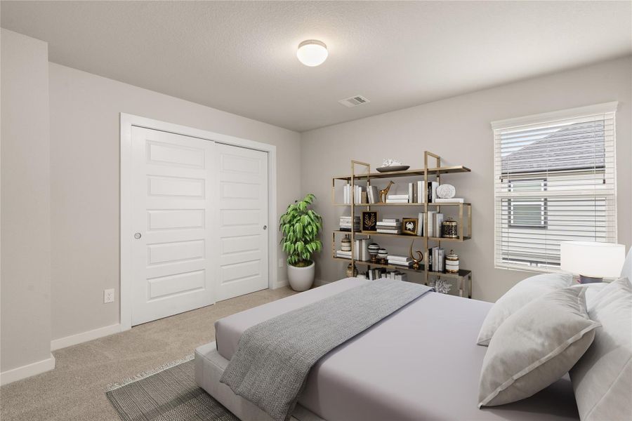 This is a cozy, well-lit bedroom featuring neutral walls and carpet. It has a large window with blinds, a modern ceiling light, and a double-door closet. The room is tastefully decorated with a bed and a stylish shelving unit.