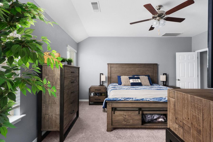 Primary bedroom with lofted ceilings. Primary bedroom with lofted ceilings.