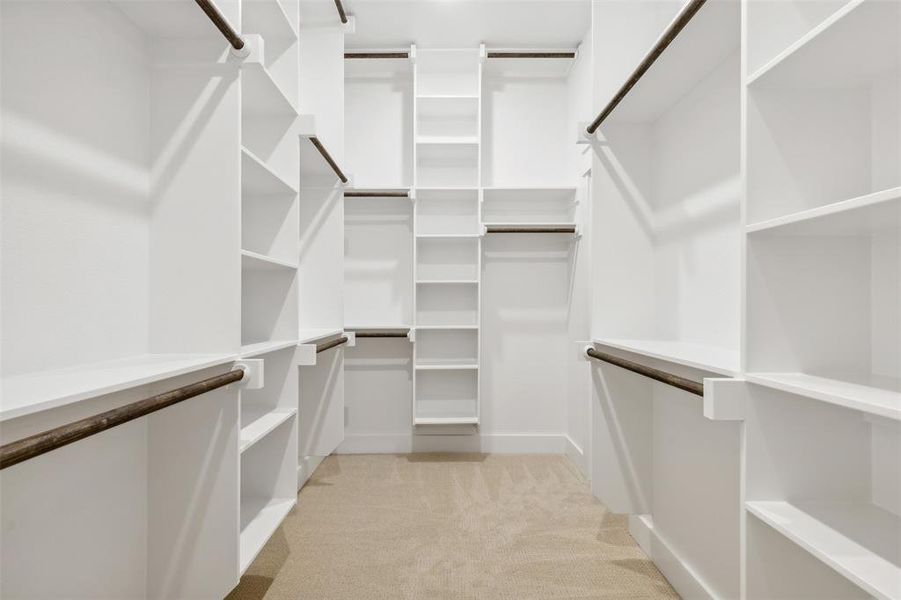 Walk in closet with light carpet