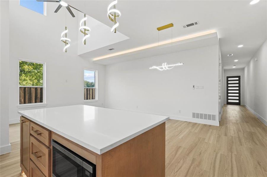 Kitchen featuring brown cabinetry, light wood finished floors, and light countertops