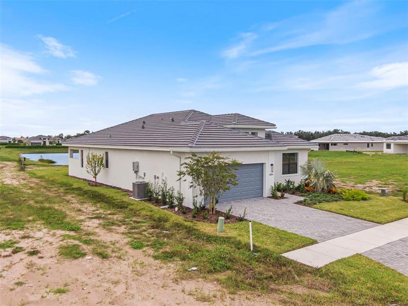 Front exterior of a new home in Cresswind Lakewood Ranch, Lakewood Ranch, FL, highlighting curb appeal (Image 25).