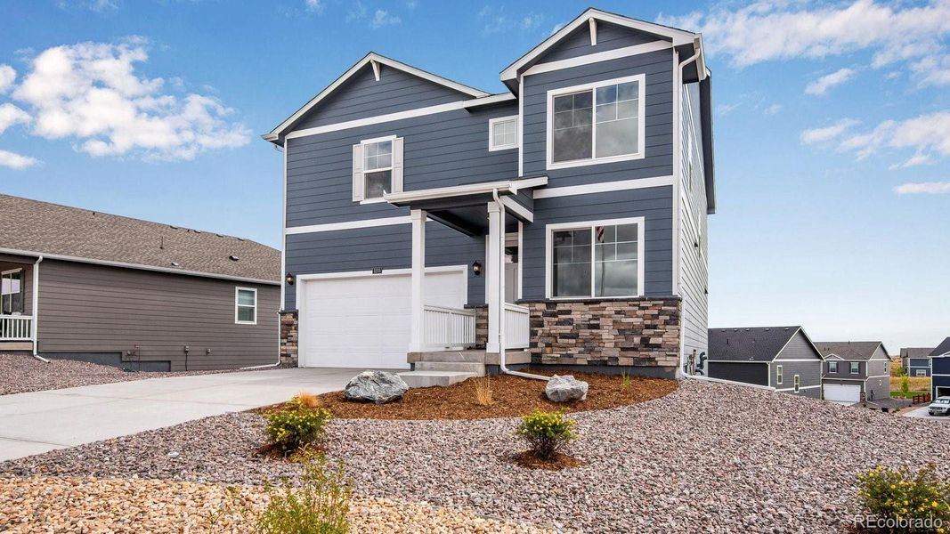 Front exterior of a new home in Settlers Crossing, Commerce City, CO, highlighting curb appeal (Image 17). Front exterior of a new home in Settlers Crossing, Commerce City, CO, highlighting curb appeal (Image 17).