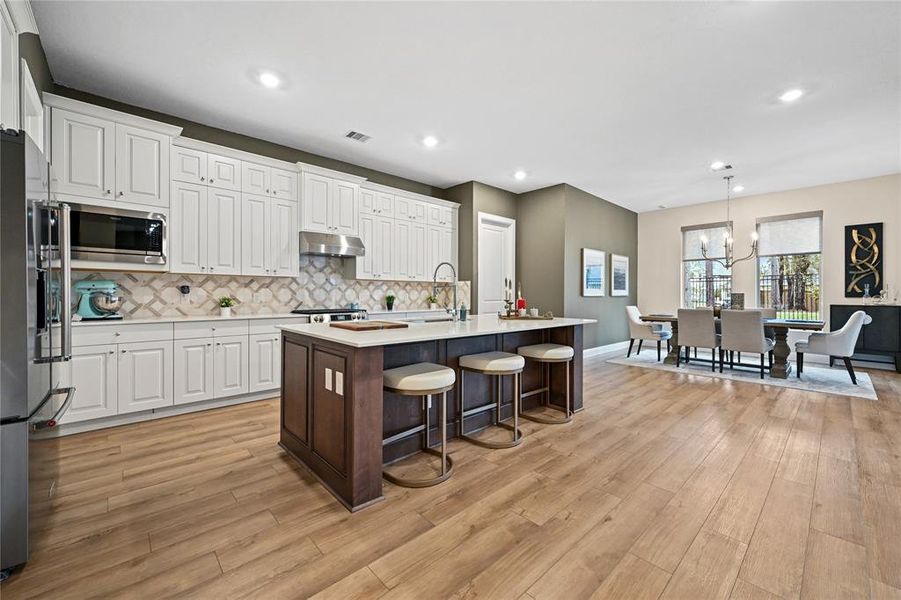 FRIGIDAIRE GALLERY STAINLESS APPLIANCES. J KRAFT CABINETRY. STYLISH AND DURABLE QUARTZ COUNTERTOPS. STAINLESS STEEL UNDERMOUNT SINGLE-BOWL SINK. FAUCET WITH PULL-DOWN SPRAY. FULL -HEIGHT BACKSPLASH. LED RECESSED LIGHTING. SPACIOUS PANTRY.