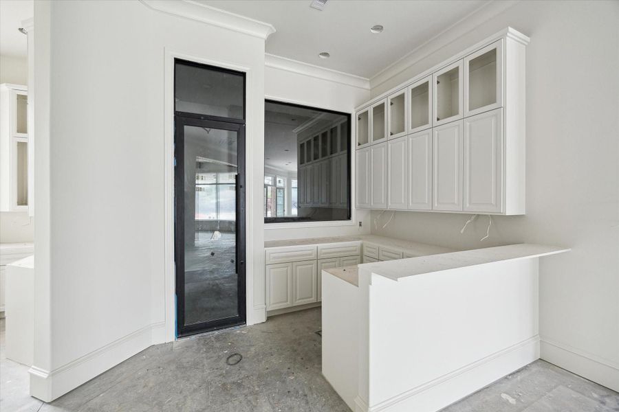 Progress photo from December 2025 - Wet bar opens up to entertaining space and will feature a walk-in climate-controlled wine room
