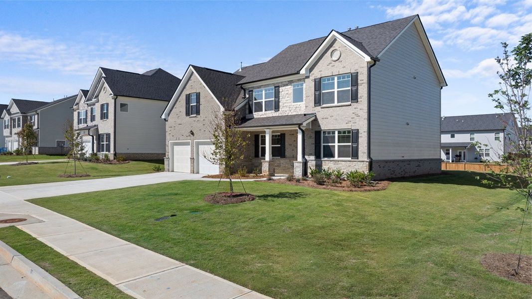 Front exterior of a new home in Independence, Loganville, GA, highlighting curb appeal (Image 2). Front exterior of a new home in Independence, Loganville, GA, highlighting curb appeal (Image 2).