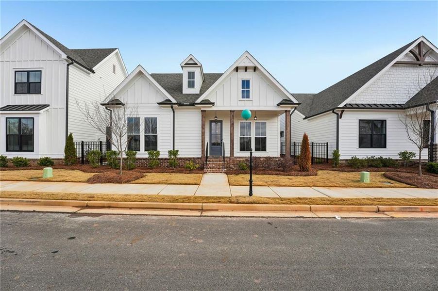 Front exterior of a new home in Promenade at Sawnee Village, Cumming, GA, highlighting curb appeal (Image 23).