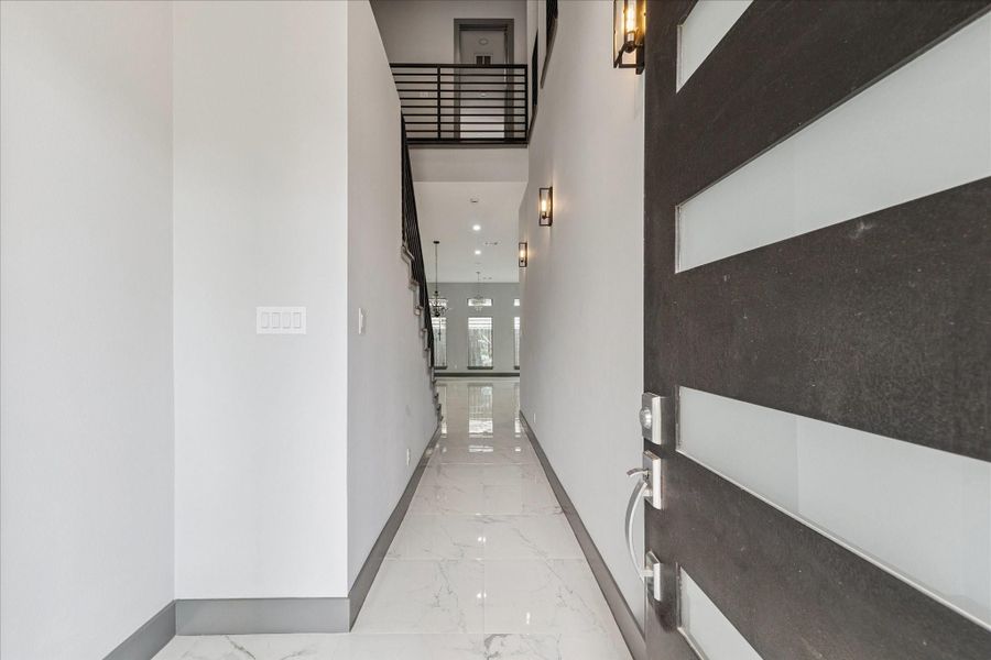 A bright, open ambiance greets you in the foyer, where tile flooring extends across the main level and the staircase with upper railing draws the eye upward for added dimension. A bright, open ambiance greets you in the foyer, where tile flooring extends across the main level and the staircase with upper railing draws the eye upward for added dimension.