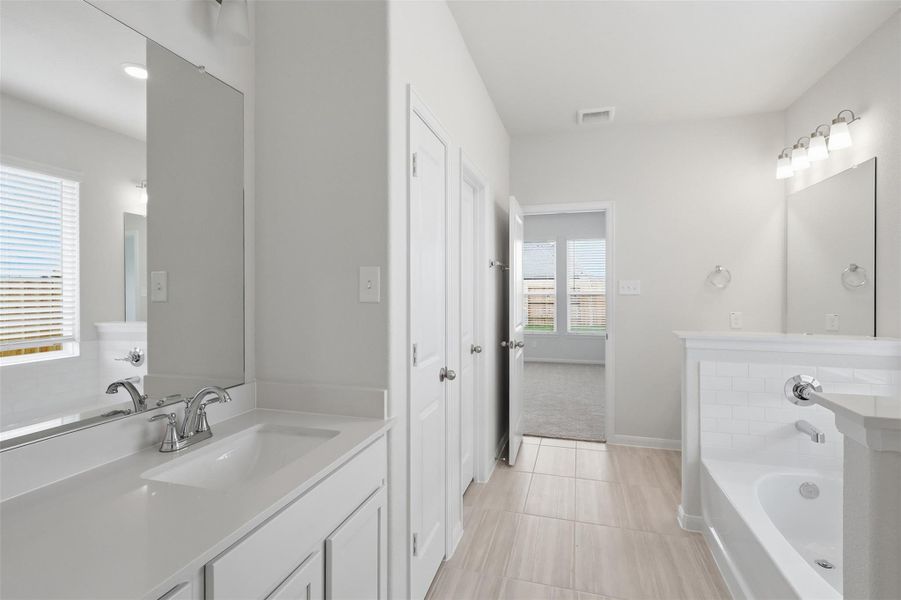 Extended vanity area with ample counter space and storage, perfect for busy mornings, leading into a bright and well designed bathroom layout. Extended vanity area with ample counter space and storage, perfect for busy mornings, leading into a bright and well designed bathroom layout.