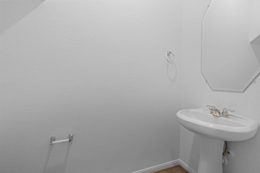 This charming home features a beautifully appointed half bath adjacent to the family room, perfect for welcoming guests and adding convenience to your daily life. This charming home features a beautifully appointed half bath adjacent to the family room, perfect for welcoming guests and adding convenience to your daily life.