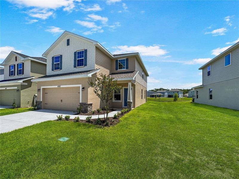 Front exterior of a new home in Harmony Central, Harmony, FL, highlighting curb appeal (Image 7).