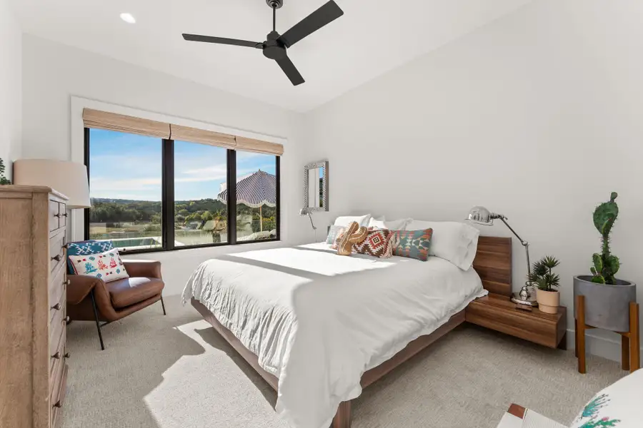 Bedroom with light carpet, a ceiling fan, recessed lighting, and vaulted ceiling Bedroom with light carpet, a ceiling fan, recessed lighting, and vaulted ceiling