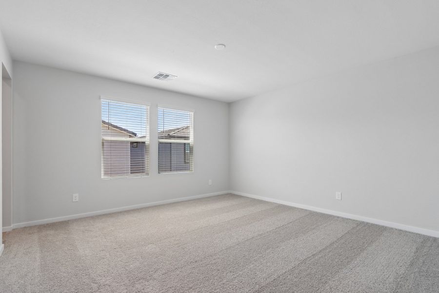 A room with a window and blinds.