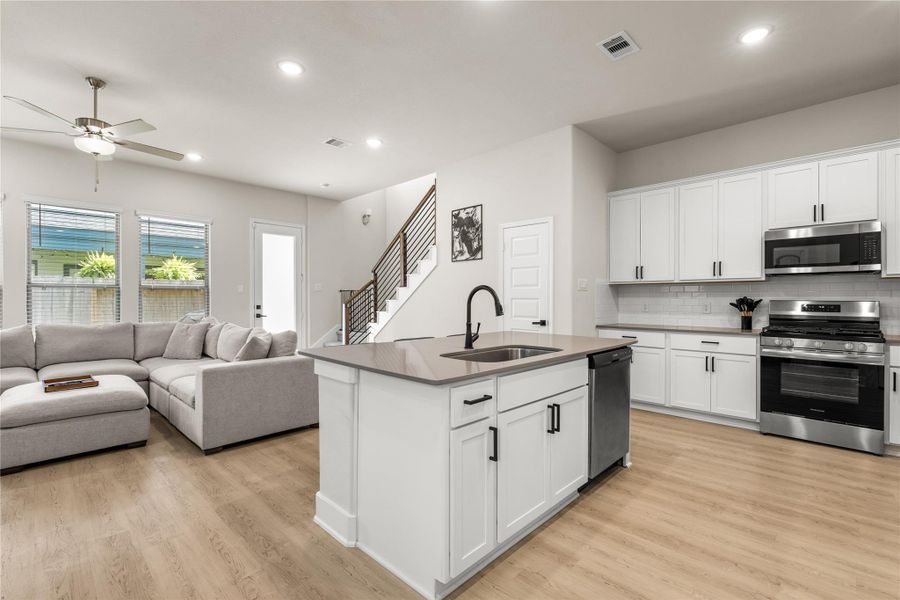 Abundant cabinetry, a walk-in pantry, and stainless steel appliances ensure the kitchen is equipped for both everyday convenience and long-term functionality, with storage thoughtfully integrated throughout the space.
