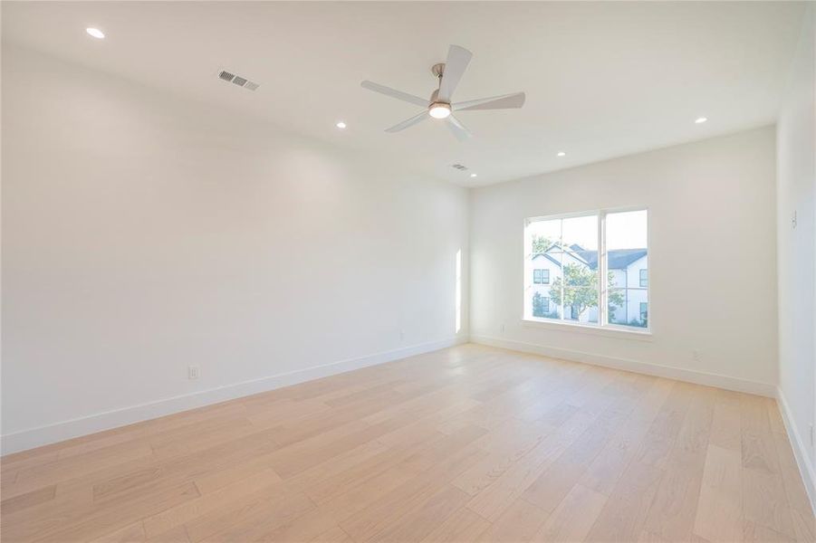 Empty room with light wood-type flooring and ceiling fan