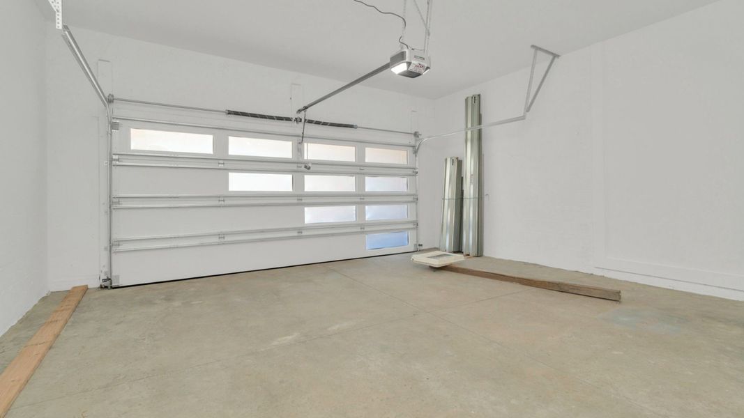 The Garage of a DRB Homes Grand Hawk which is offered as a home plan at Serengeti in Spring Hill, FL.