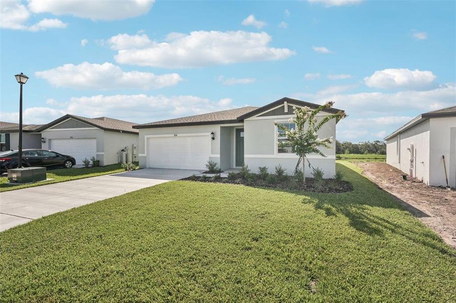 Front exterior of a new home in Salt Meadows - Classic Series, Parrish, FL, highlighting curb appeal (Image 16). Front exterior of a new home in Salt Meadows - Classic Series, Parrish, FL, highlighting curb appeal (Image 16).