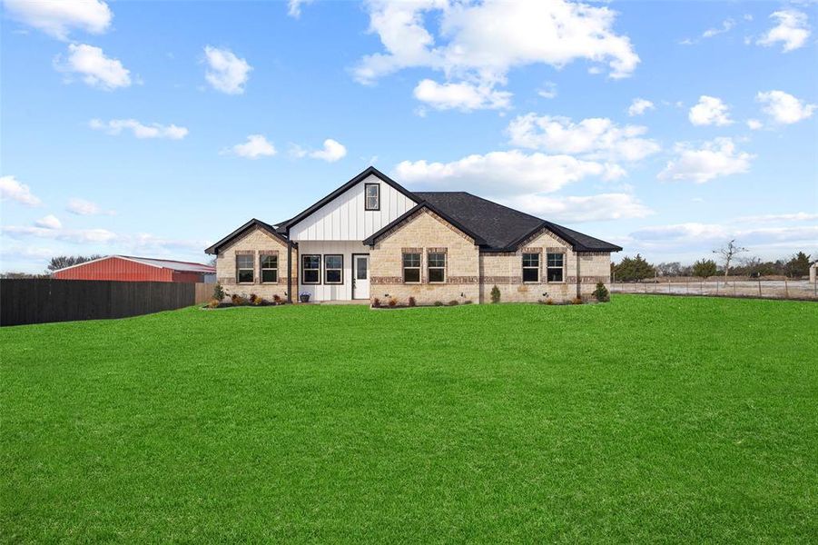 Spacious property featuring a large green lawn surrounding a single-story residence Spacious property featuring a large green lawn surrounding a single-story residence