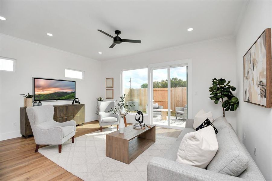 Large open living space bathed in natural light and sliding door access to the back patio.