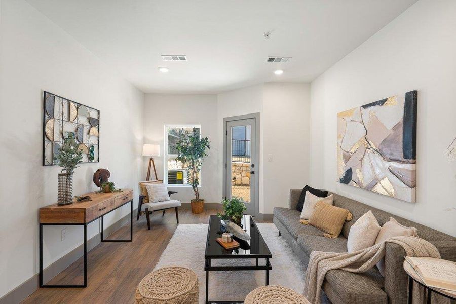 Living room featuring dark wood-type flooring and recessed lighting