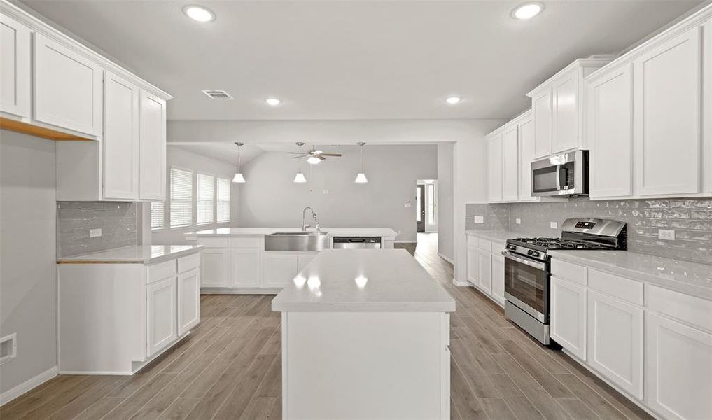 Island kitchen with plenty of cabinet space (*Photo not of actual home and used for illustration purposes only.)