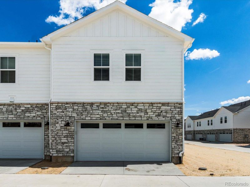 Front exterior of a new home in Skyview at High Point, Aurora, CO, highlighting curb appeal (Image 23).