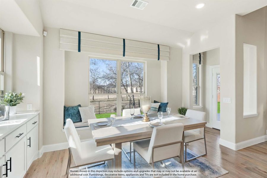 Dining area with rectangular table, white chairs, window bench seat, and hardwood floors Dining area with rectangular table, white chairs, window bench seat, and hardwood floors