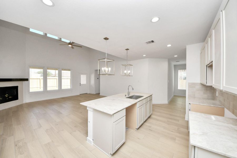 The extended counter area adds both practicality and style, making meal preparation a breeze. Every detail is thoughtfully designed to enhance the kitchen's functionality and aesthetic appeal. Sample photo of completed home with similar floor plan. Actual colors and selections may vary.