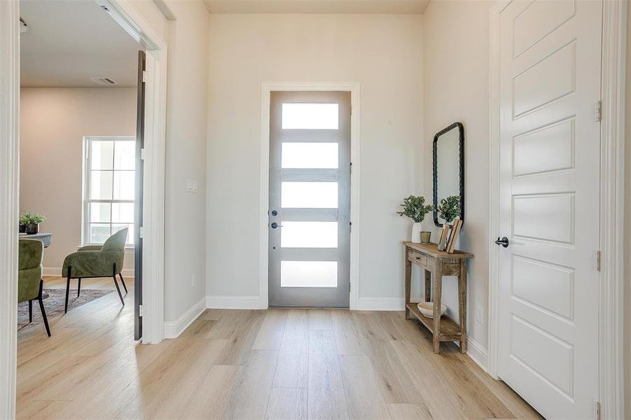 Entryway with light hardwood / wood-style floors and a wealth of natural light