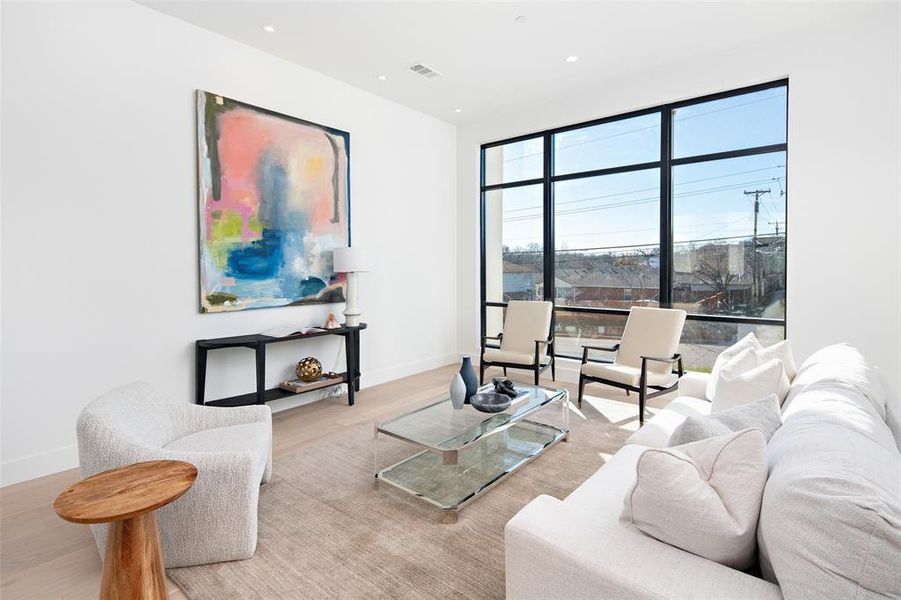 Living room with light wood-type flooring and plenty of natural light