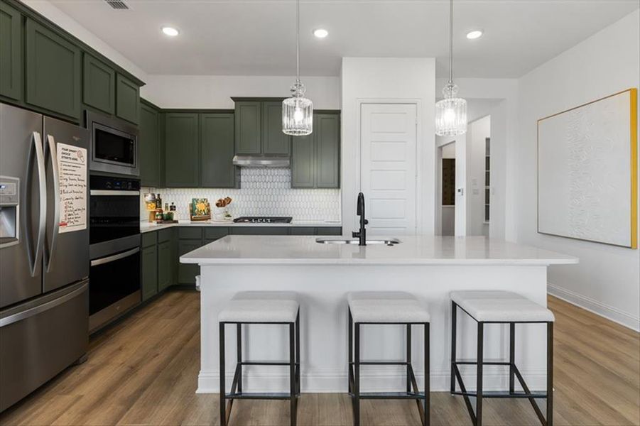 Kitchen w/ Quartz Countertops and Tile Backsplash