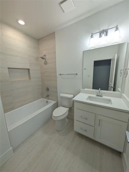 Full bath featuring vanity,  shower combination, and wood finished floors