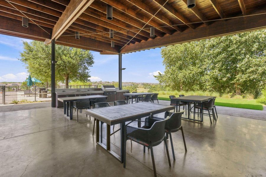 Polished concrete floors and a massive wood-beamed ceiling define this expansive covered outdoor pavilion.