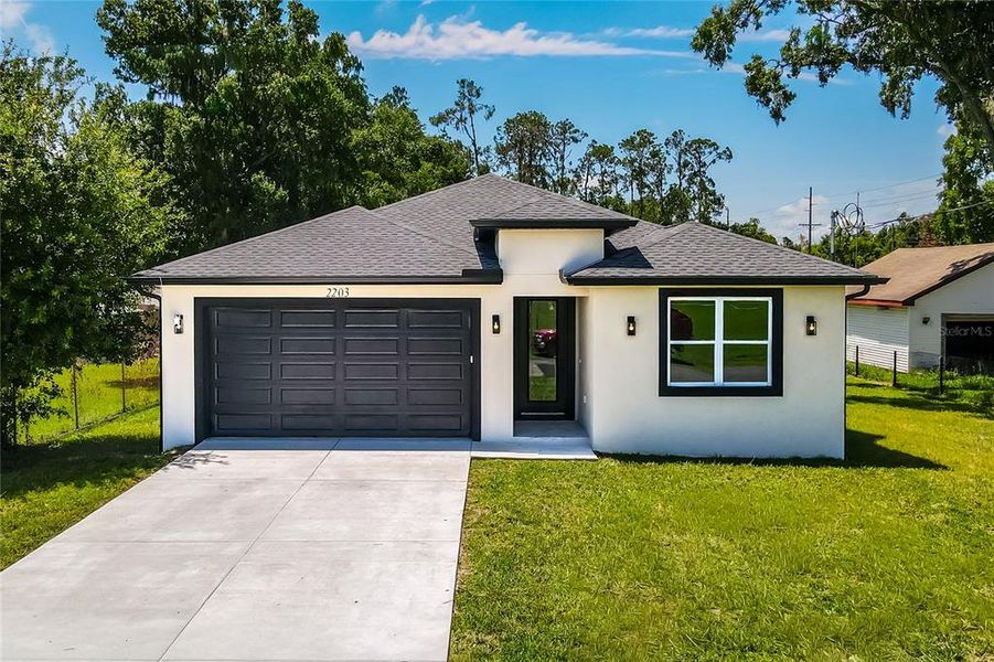 Front exterior of a new home in , Plant City, FL, highlighting curb appeal (Image 1). Front exterior of a new home in , Plant City, FL, highlighting curb appeal (Image 1).
