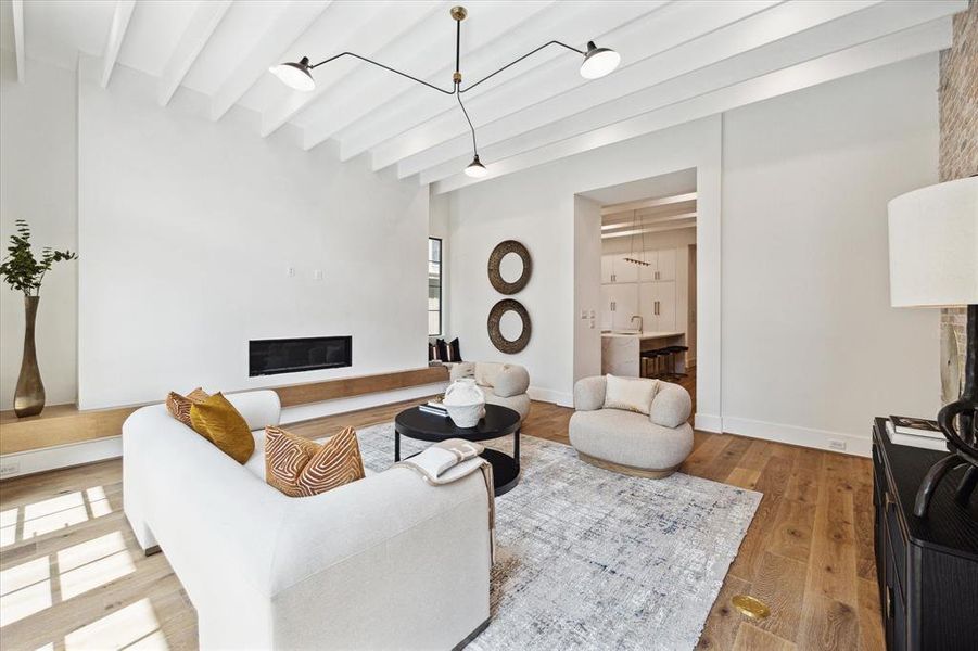 Chantilly White plaster and a custom floating White Oak hearth surround the focal point linear gas fireplace.