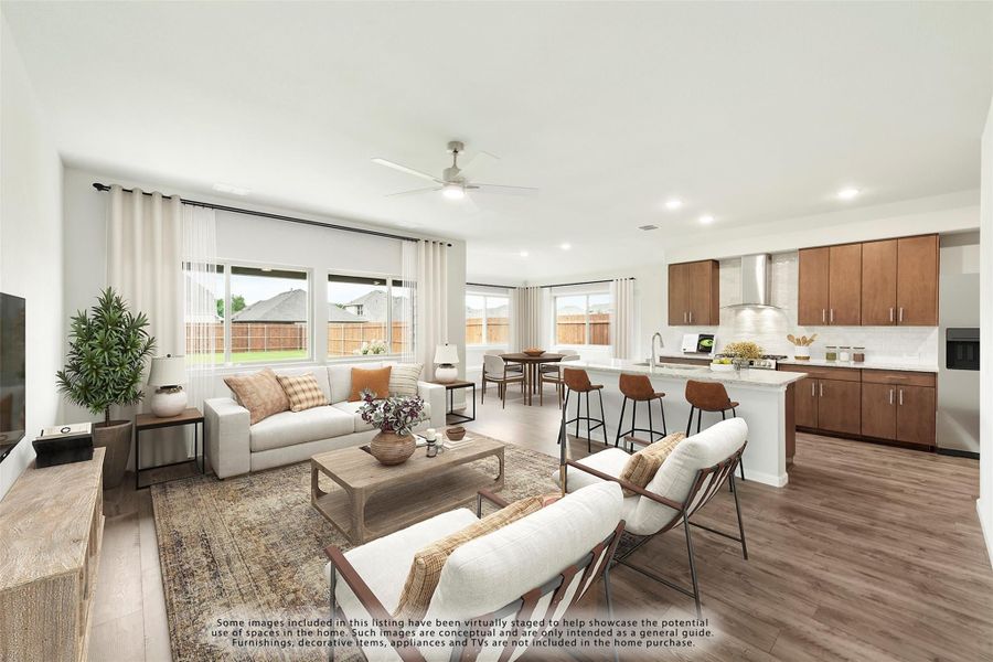 Open-concept living room and kitchen with hardwood floors, ceiling fan, and wood cabinets