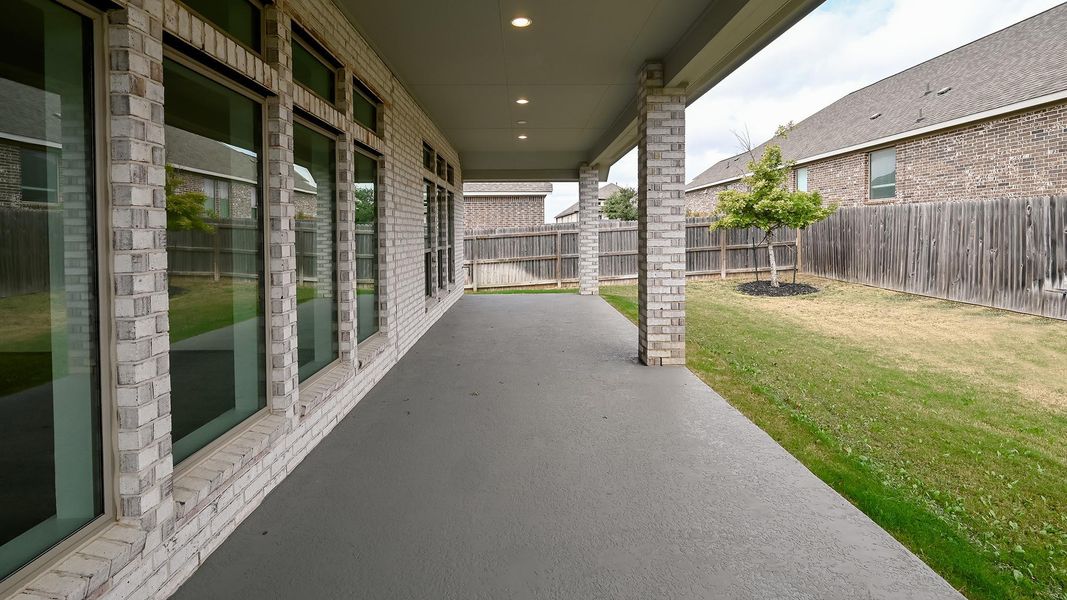 Fenced backyard with a patio area Fenced backyard with a patio area