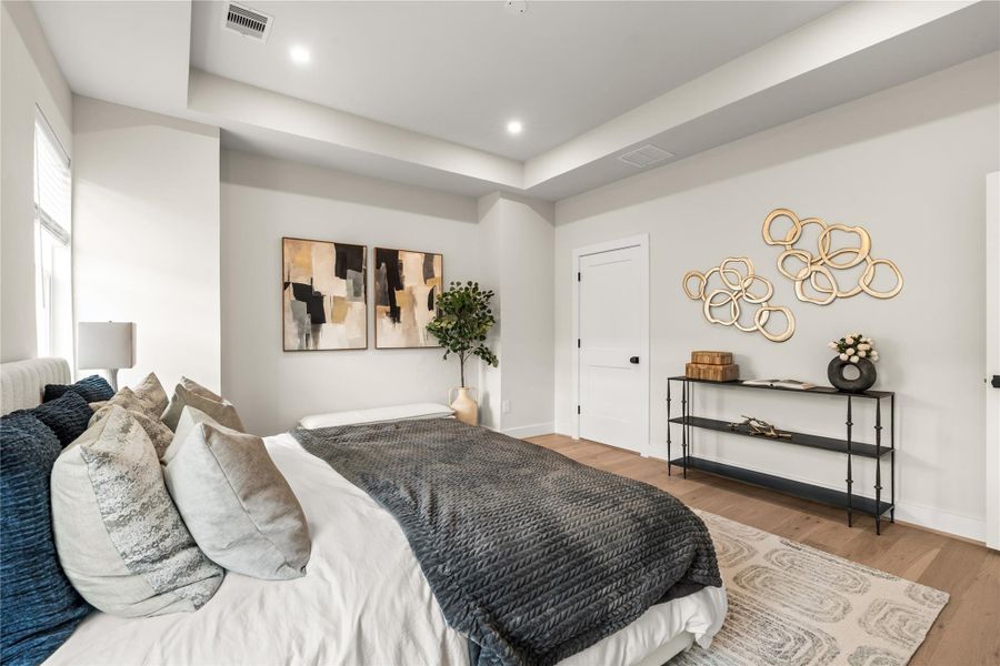 A second perspective emphasizes the primary bedroom’s depth and uninterrupted wall space, leaving flexibility for dressers or additional seating.