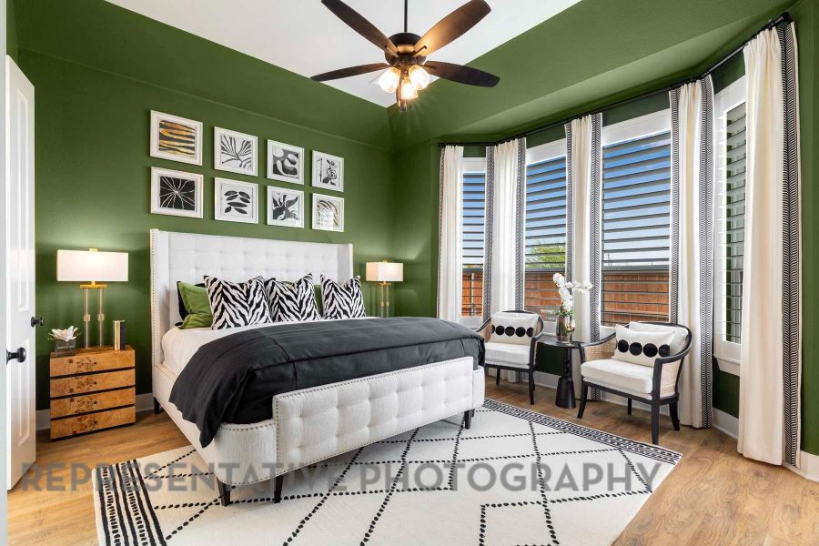 Bedroom featuring wood finished floors, ceiling fan, and baseboards Bedroom featuring wood finished floors, ceiling fan, and baseboards