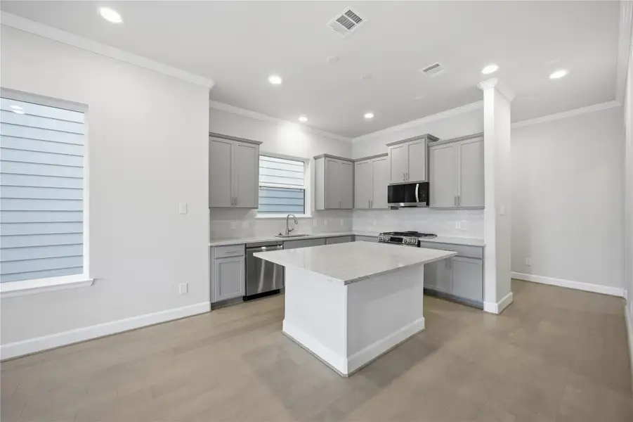A Chef’s Dream Kitchen – Modern quartz countertops, stainless steel appliances, and a functional island make this kitchen the heart of the home.