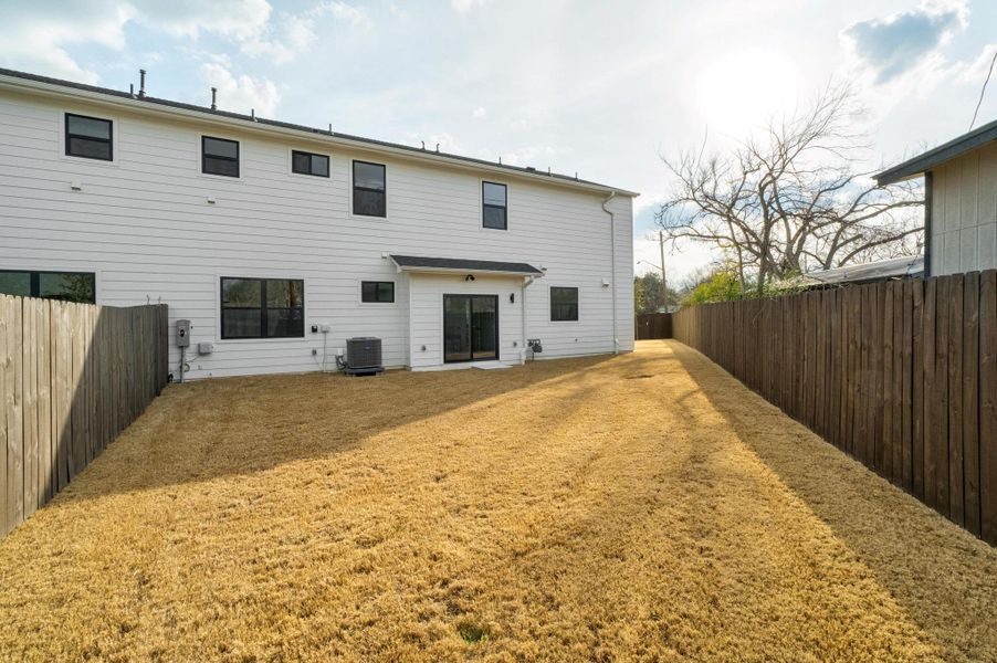Rear view of house with a patio and a fenced backyard