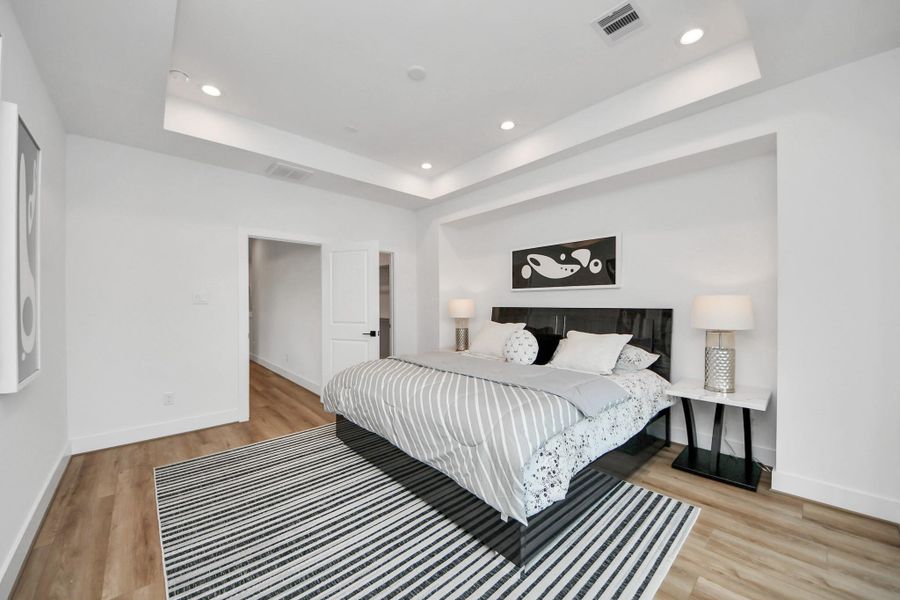Experience comfort and style in this elegant primary bedroom, featuring sleek modern design, abundant natural light, and a serene ambiance perfect for relaxation.