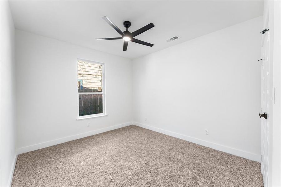 Unfurnished room featuring carpet floors and ceiling fan
