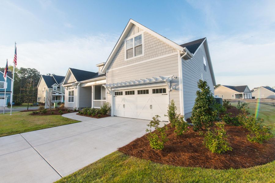 Representative exterior photo of a completed home built from the Helmsley by Bill Clark Homes in The Sanctuary at Sunset Beach, Sunset Beach, NC (Image 31). Representative exterior photo of a completed home built from the Helmsley by Bill Clark Homes in The Sanctuary at Sunset Beach, Sunset Beach, NC (Image 31).