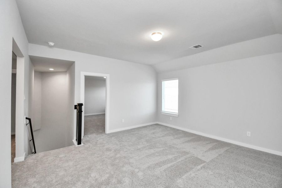 Come upstairs and enjoy a day of leisure in this fabulous game room! This is the perfect hangout spot or adult game room! Features plush carpet, high ceilings, custom paint and windows for plenty of natural light.
