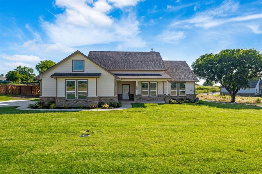 View of front facade featuring a shingled roof and brick siding View of front facade featuring a shingled roof and brick siding