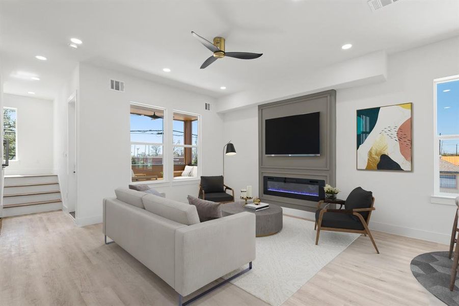 Virtually Staged: This stunning living room features new recessed lighting and vinyl plank floors, and a gorgeous electric fireplace that puts out heat.