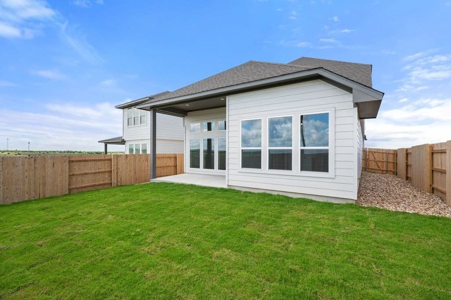 Exterior details and patio area of a home in Terrace Collection At Turner's Crossing, Buda (Image 29).