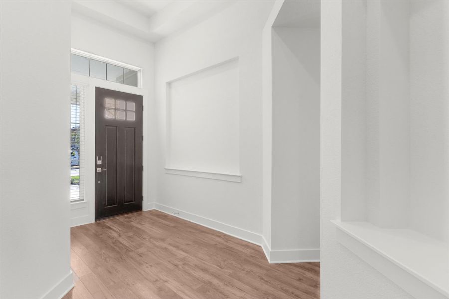 Entrance foyer with wood finished floors and baseboards